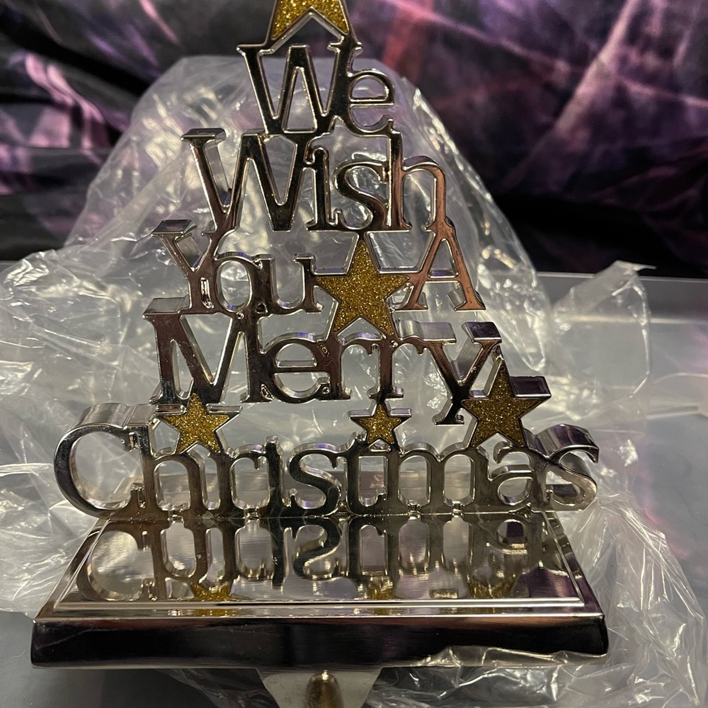 We Wish You A Merry Christmas weighted bottom metal stocking hanger. New